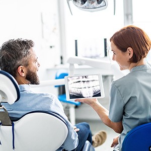 Patient and dentist looking at X-ray