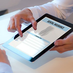 Patient reviewing dental insurance form in office
