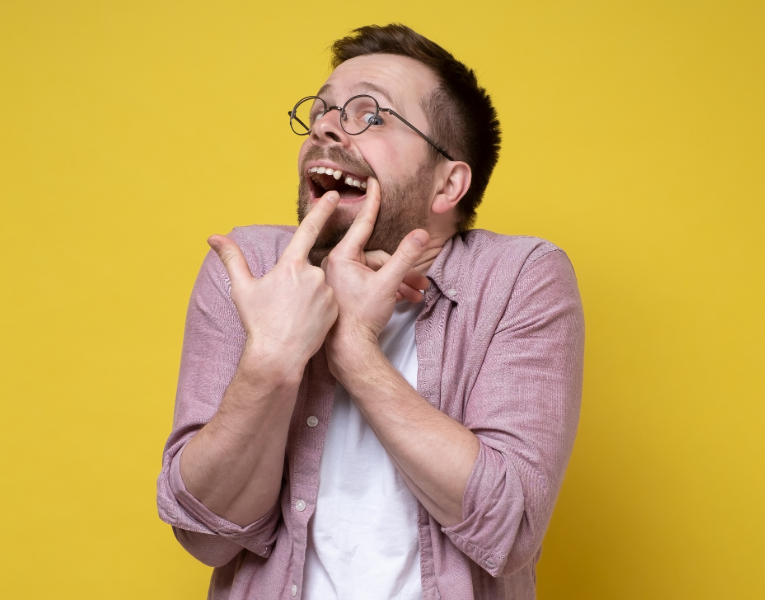 Man pointing at missing tooth